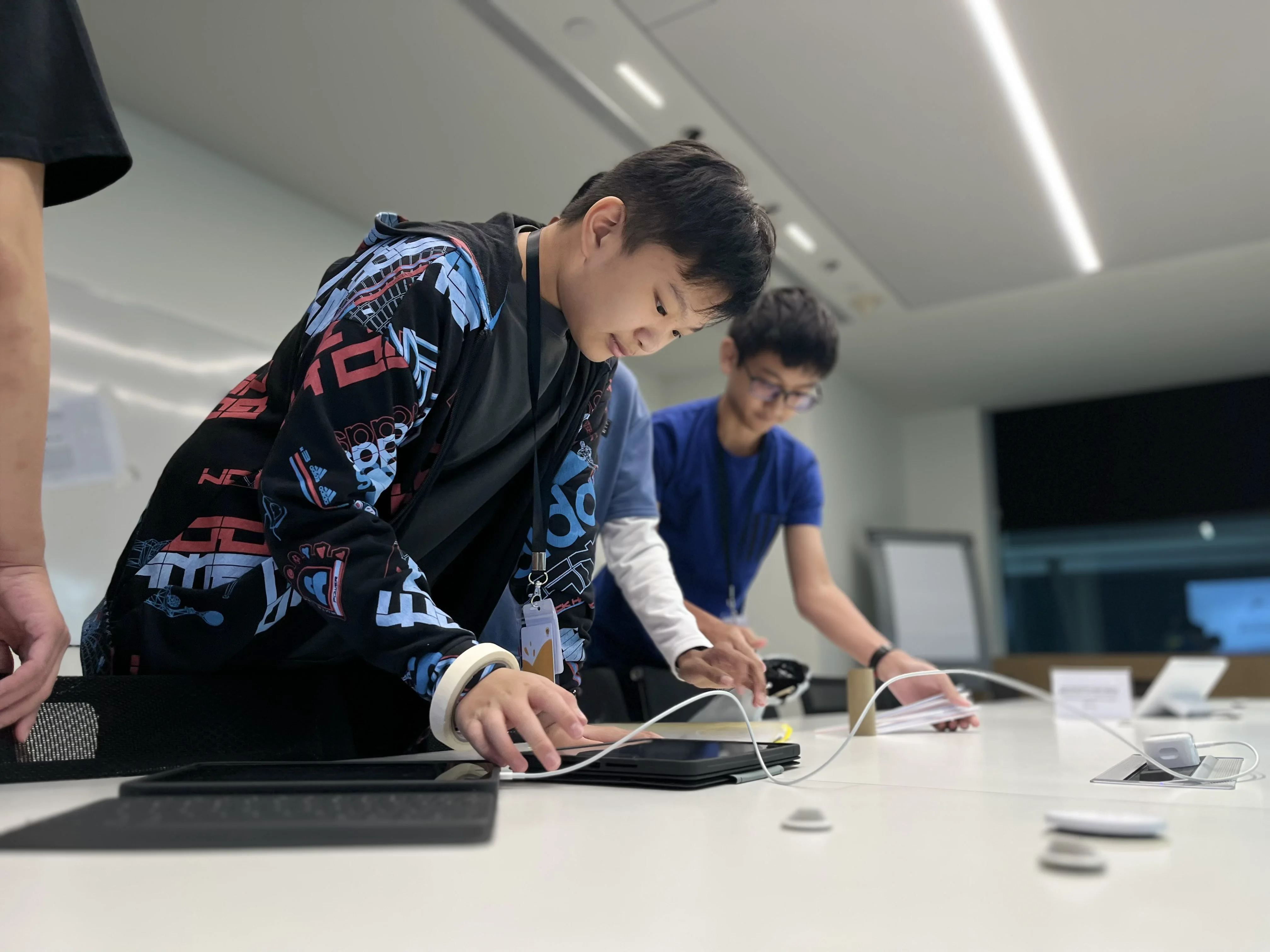 Ethan working with other students at a technology event