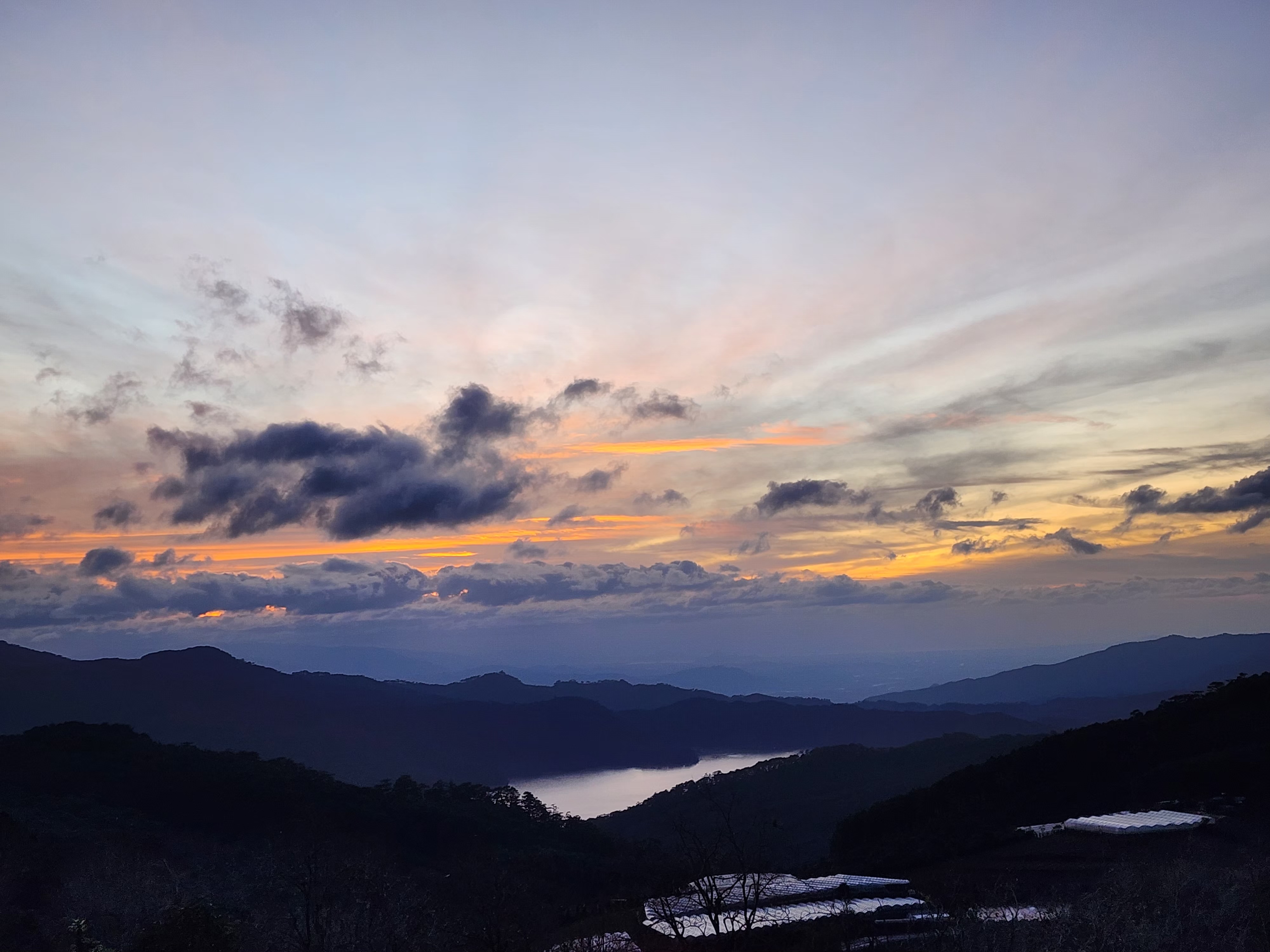 Layered mountain ridges beneath a warm dusk sky