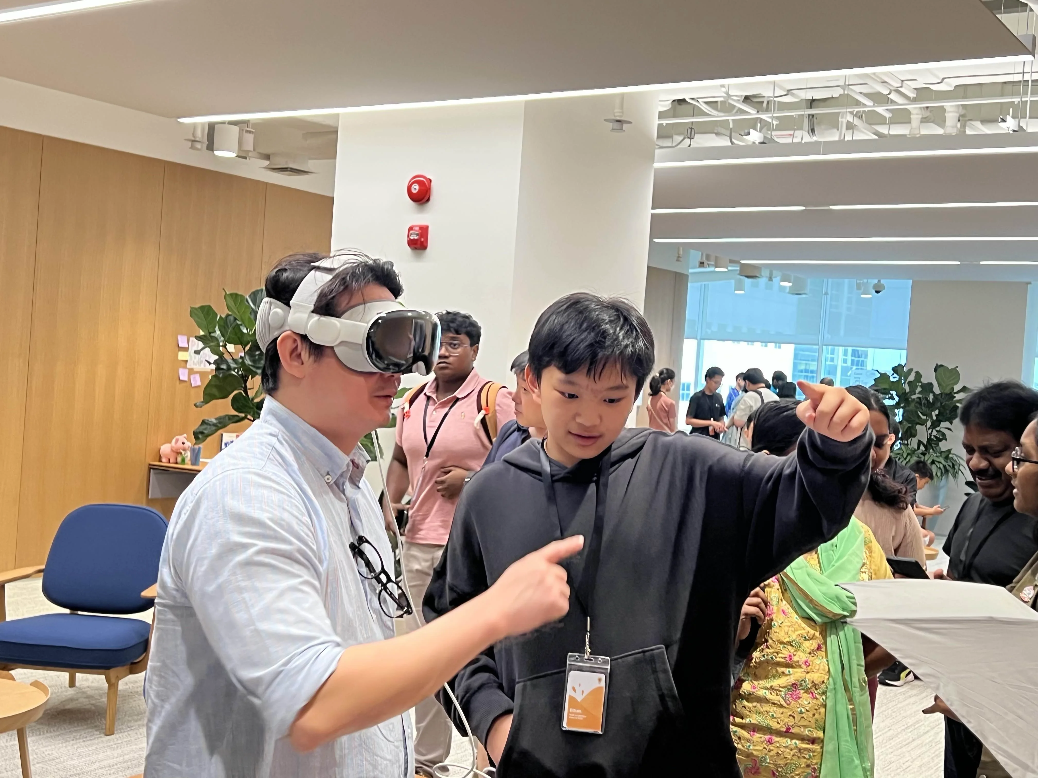 Ethan helping at a technology event with an Apple Vision Pro